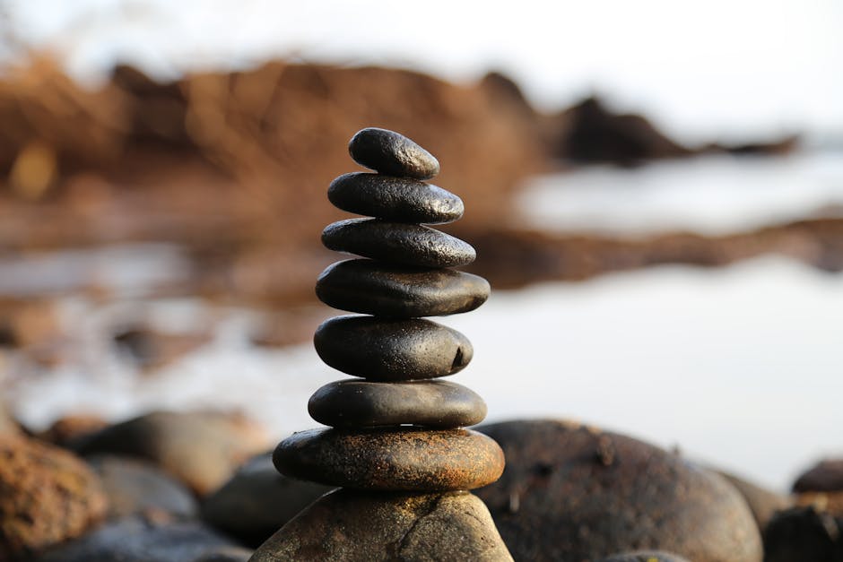 A perfectly balanced stack of smooth stones on a blurred natural background